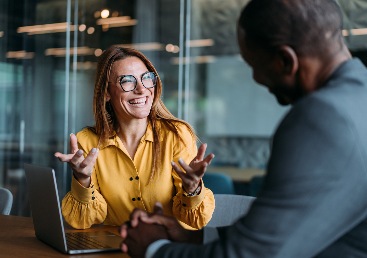 Smiling professionals discussing work in office