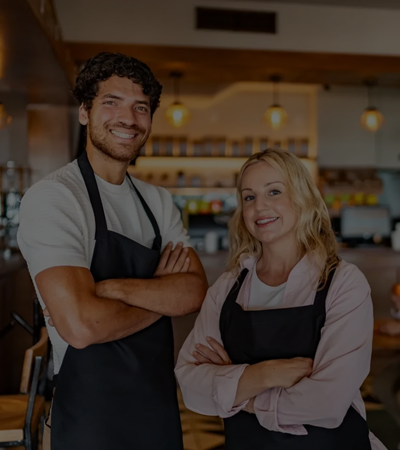 Happy cafe workers in aprons